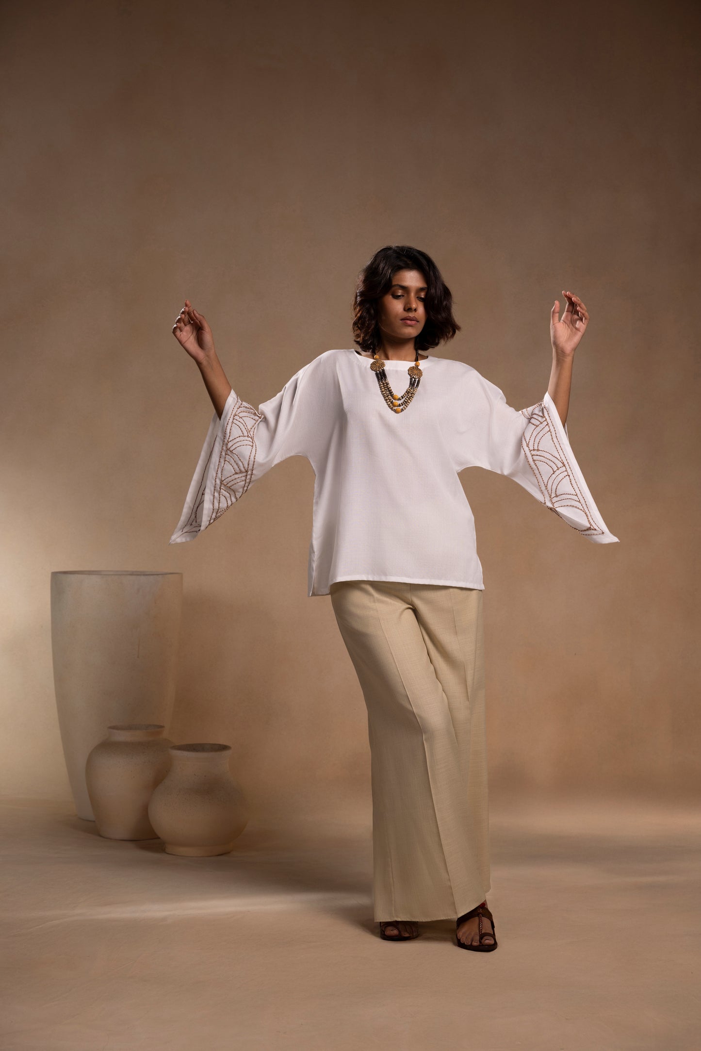 White cotton relaxed-fit top with round neck and sleeves for effortless comfort